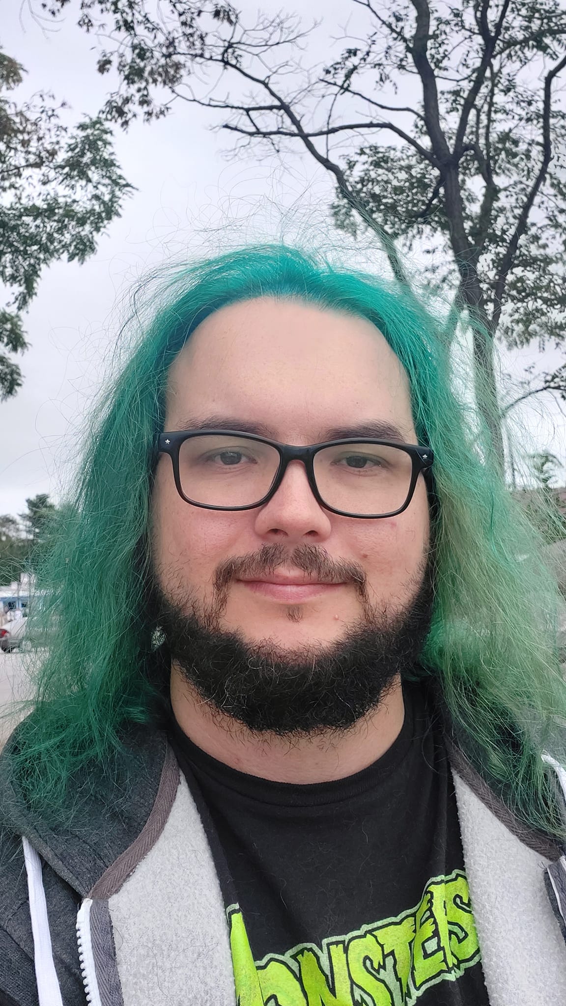 A man with green hair stands outside, photo 5